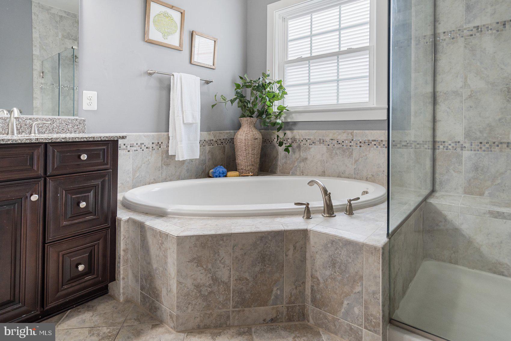 7429 Matapan Drive Hanover, MD 21076 - Photo 21 of 37 a bath tub sitting in a bathroom next to a window