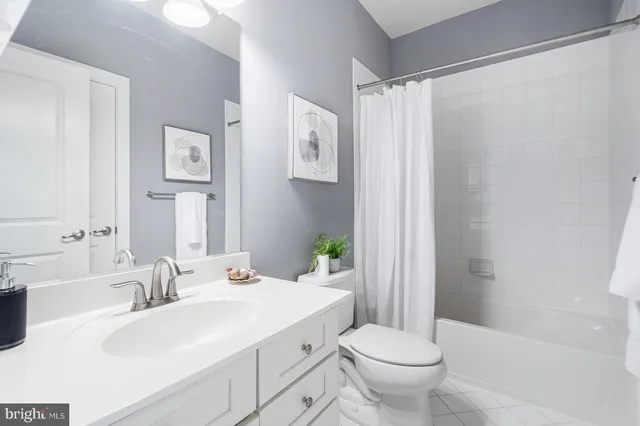 a view of bathroom with a toilet sink mirror and vanity