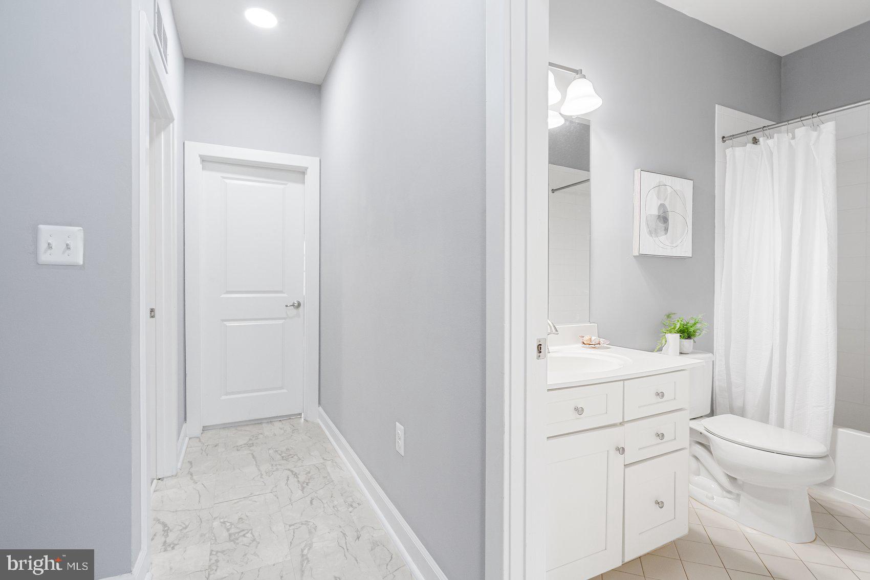 7429 Matapan Drive Hanover, MD 21076 - Photo 26 of 37 a view of bathroom with a toilet sink mirror and vanity