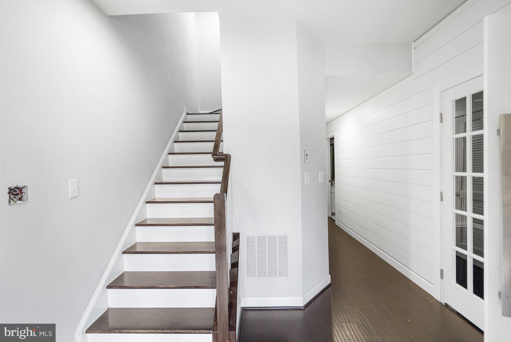 7429 Matapan Drive Hanover, MD 21076 - Photo 32 of 37 a view of entryway with stairs and wooden floor