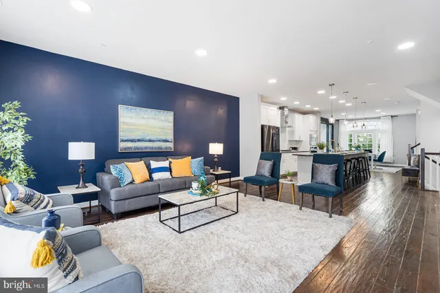 a living room with furniture and kitchen view