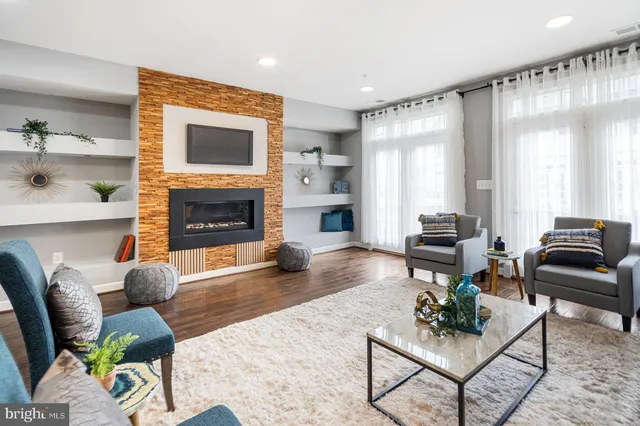 a living room with furniture flat screen tv and a fireplace