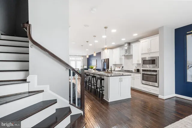 a kitchen with cabinets and wooden floor