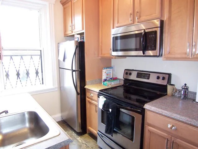 a kitchen with a stove microwave and refrigerator