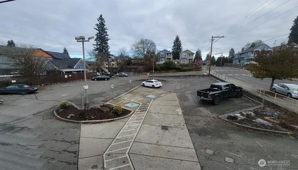 a large white kitchen with kitchen island a sink a counter top space and a living room view