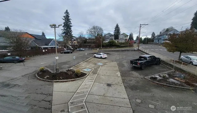 a large white kitchen with kitchen island a sink a counter top space and a living room view