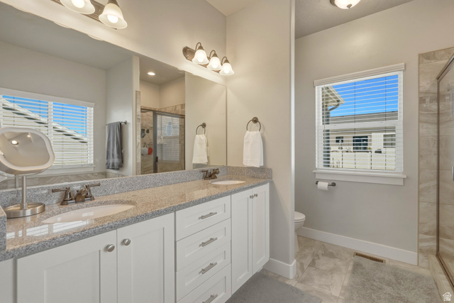 836 South 250 West Vernal, UT 84078 - Photo 12 of 56 Bathroom with double vanity, a shower stall, and plenty of natural light