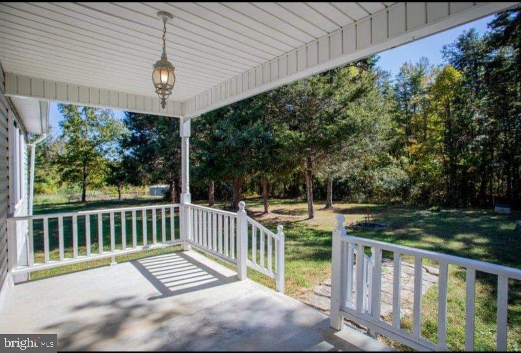 9001 Stage Coach Road Nathalie, VA 24577 - Photo 13 of 19 Serene porch with lush greenery view.