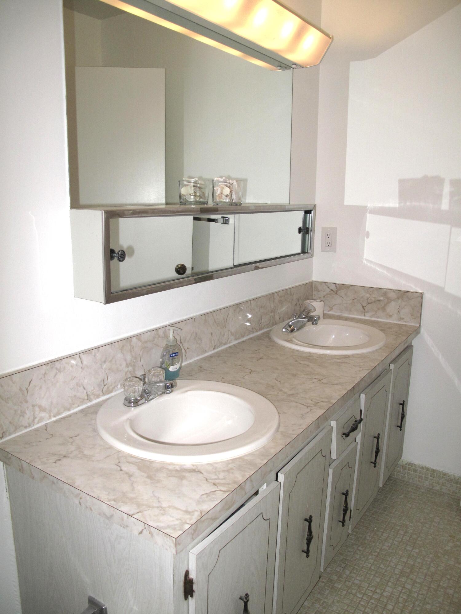 1162 Circle Drive, Unit B Delray Beach, FL 33445 - Photo 15 of 31 a bathroom with a sink and a mirror