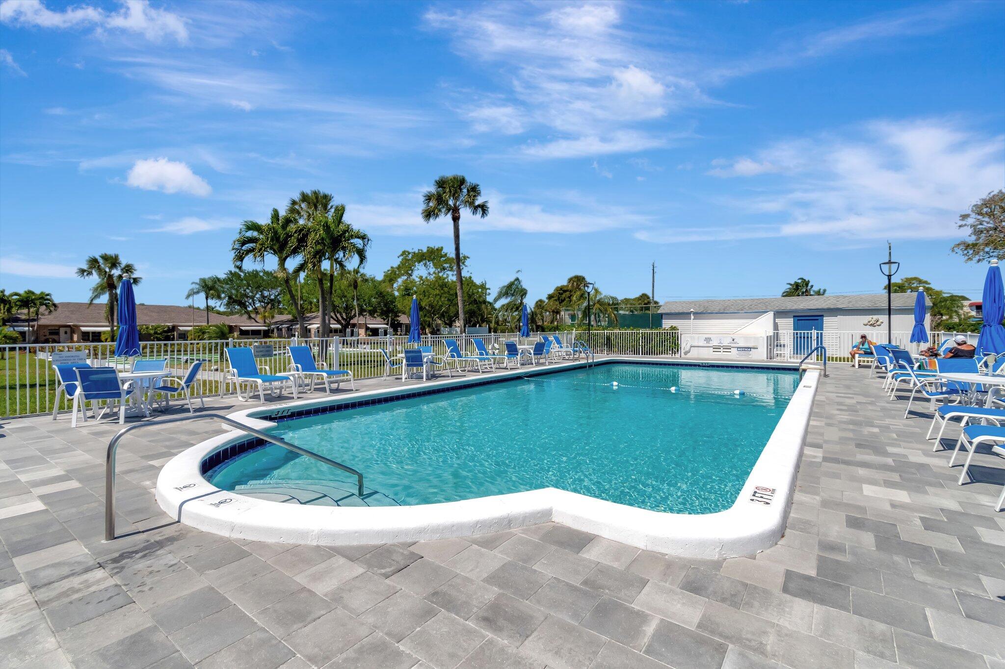 1162 Circle Drive, Unit B Delray Beach, FL 33445 - Photo 23 of 31 a view of a swimming pool with an outdoor seating