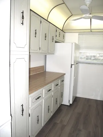 a kitchen with stainless steel appliances a refrigerator and a cabinets
