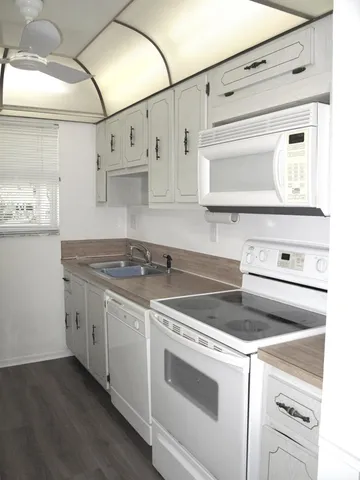 a white stove top oven sitting inside of a kitchen