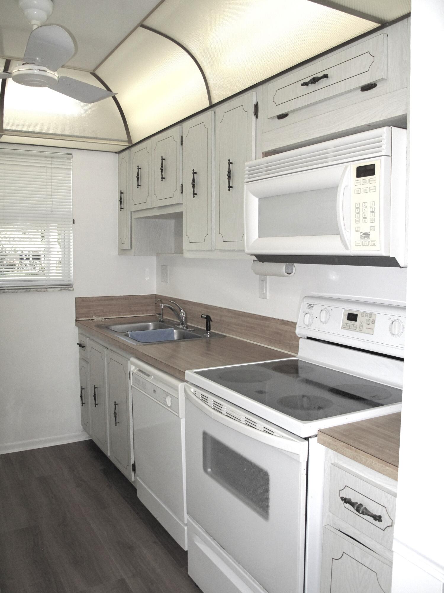 1162 Circle Drive, Unit B Delray Beach, FL 33445 - Photo 4 of 31 a white stove top oven sitting inside of a kitchen