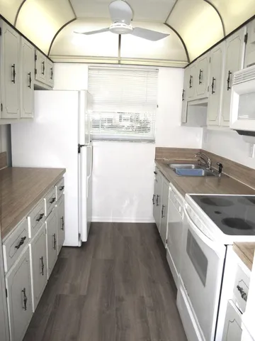 a kitchen with stainless steel appliances granite countertop a sink and a stove top oven
