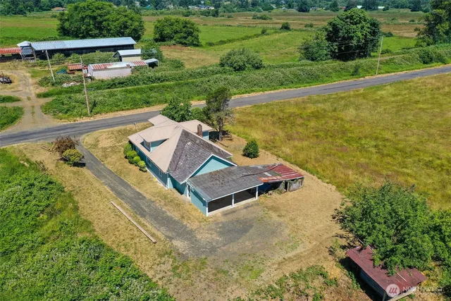an aerial view of a house with a garden and swimming pool