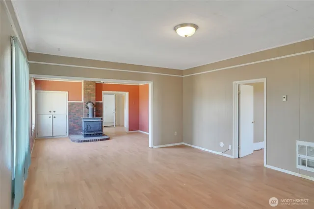 a view of a livingroom with furniture and kitchen view