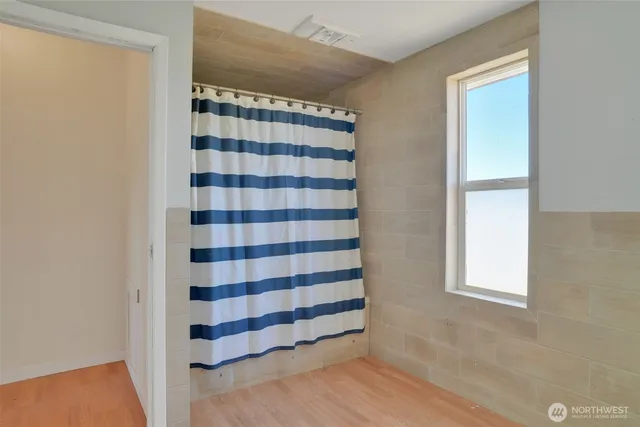 a view of a room with windows and wooden floor