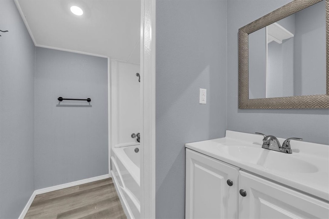 902 Calumet Avenue Waco, TX 76704 - Photo 19 of 27 a bathroom with a sink and mirror