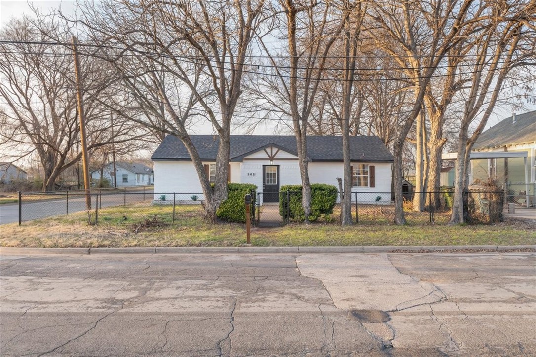 902 Calumet Avenue Waco, TX 76704 - Photo 4 of 27 a view of a house with a yard and large trees