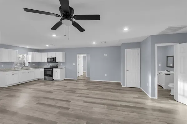 a view of a kitchen with a sink stainless steel appliances and cabinets
