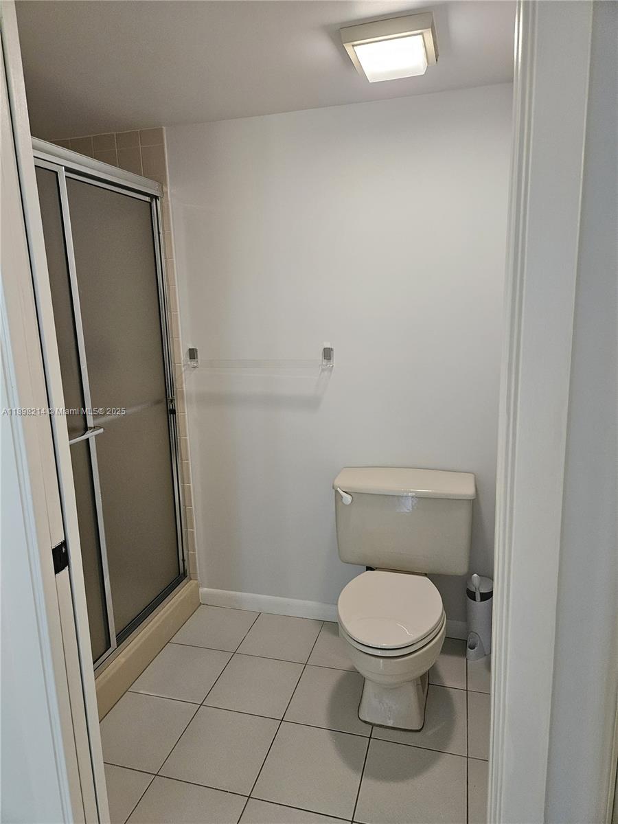 6085 Balboa Circle, Unit 403 Boca Raton, FL 33433 - Photo 17 of 32 a white toilet sitting next to a shower