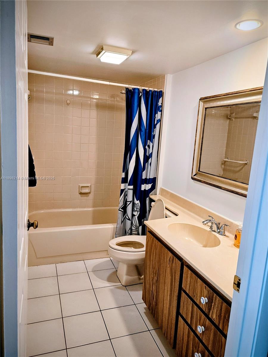 6085 Balboa Circle, Unit 403 Boca Raton, FL 33433 - Photo 21 of 32 a bathroom with a sink a toilet and shower