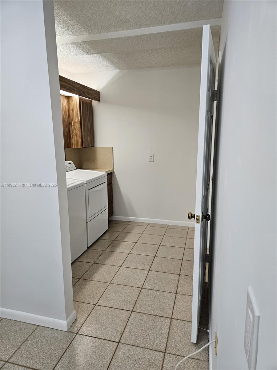 6085 Balboa Circle, Unit 403 Boca Raton, FL 33433 - Photo 22 of 32 a room with a washing machine and a sink