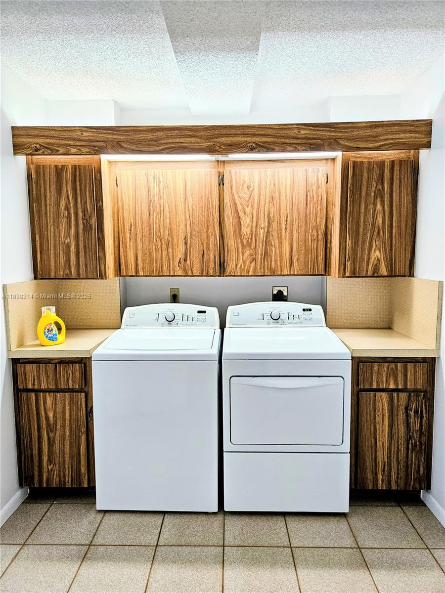 6085 Balboa Circle, Unit 403 Boca Raton, FL 33433 - Photo 23 of 32 a utility room with dryer and washer