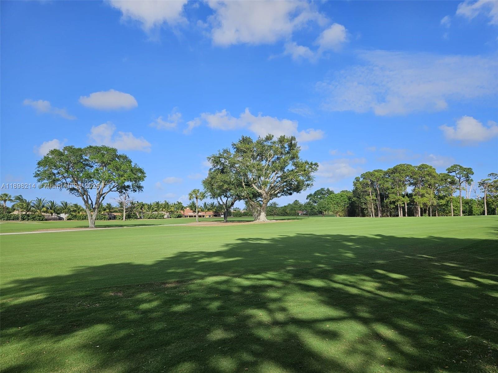 6085 Balboa Circle, Unit 403 Boca Raton, FL 33433 - Photo 30 of 32 a view of a golf course with a lake