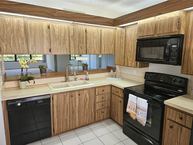 a kitchen with a sink stove and microwave