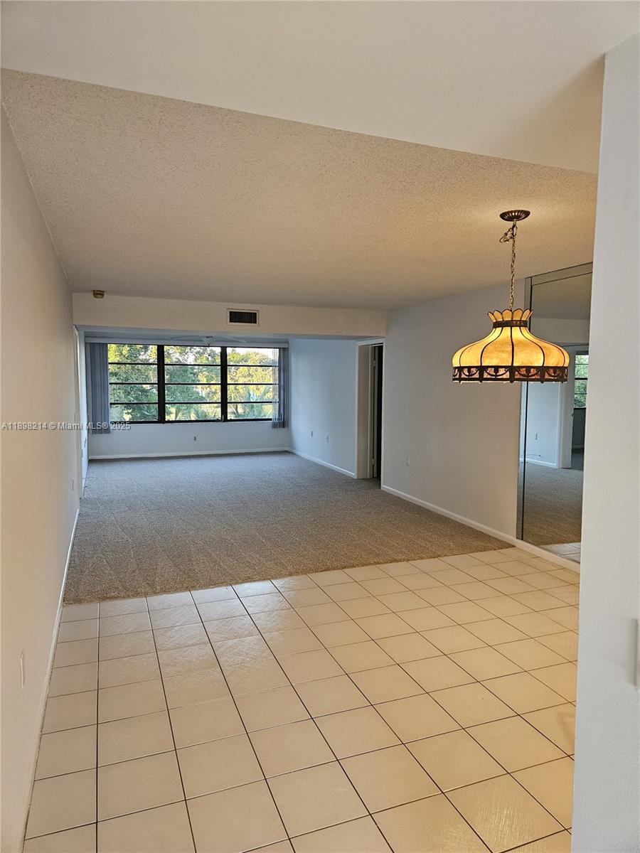 6085 Balboa Circle, Unit 403 Boca Raton, FL 33433 - Photo 8 of 32 a view of an empty room with a window