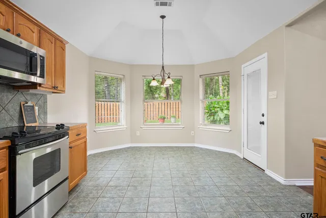 a kitchen with a stove a sink and a microwave