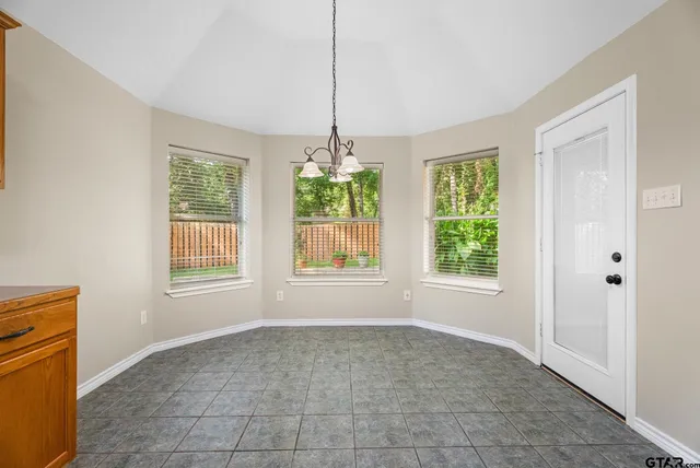 a view of a room with window and chandelier