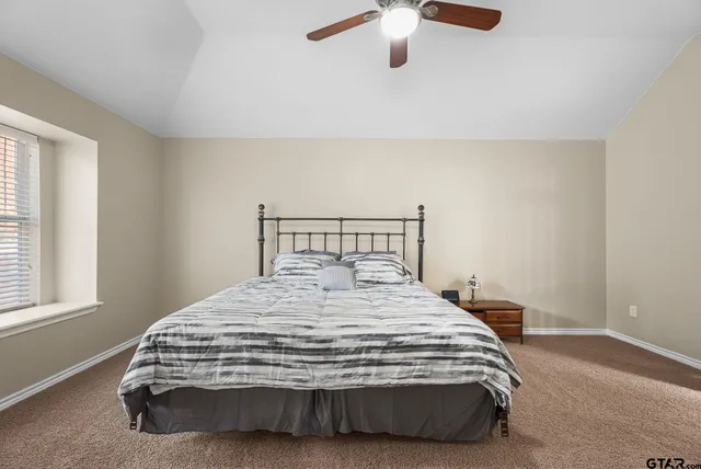 a bedroom with a bed and window