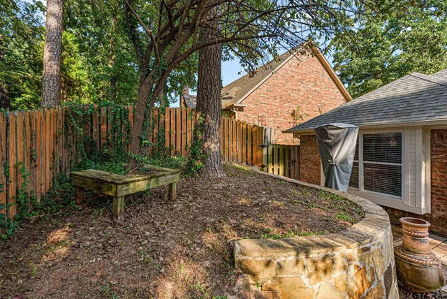 a view of a backyard with a table and chairs
