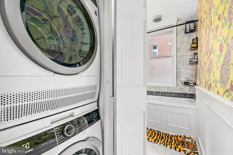 a view of washer and dryer with kitchen view