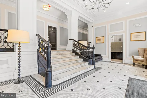 a living room with furniture and a chandelier