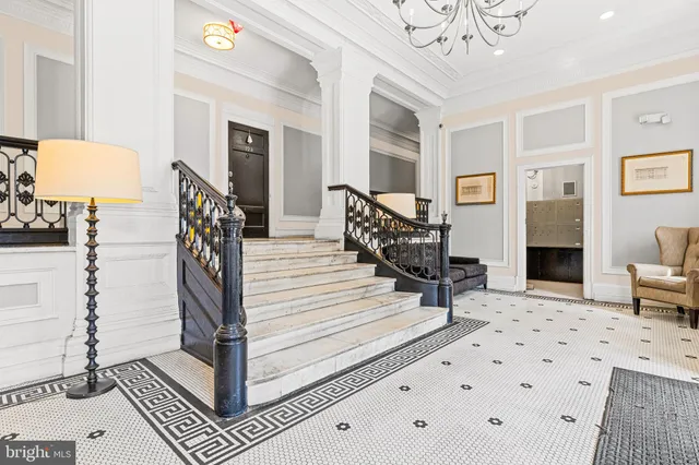 a living room with furniture and a chandelier