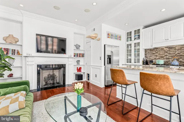 a living room with furniture and a fireplace