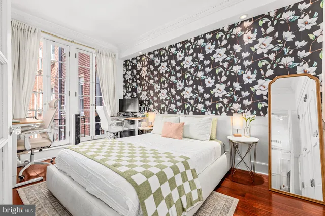 a bedroom with a large bed and a window