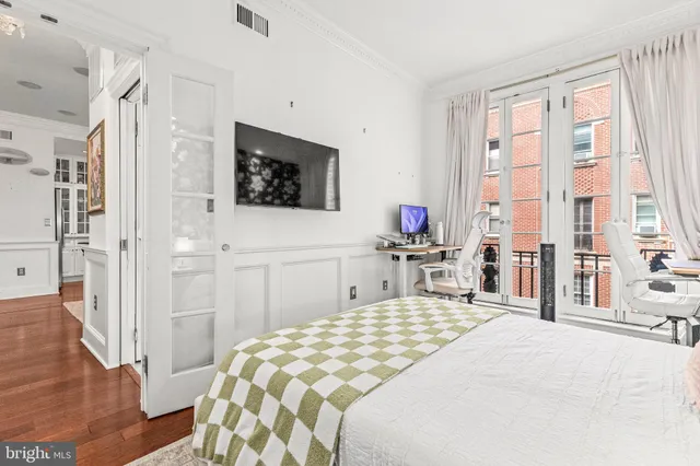 a bedroom with a bed and a flat tv screen