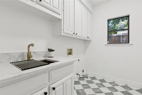 a kitchen with a sink and cabinets