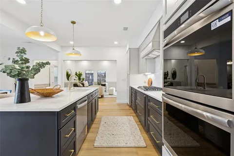 a large kitchen with kitchen island a sink stainless steel appliances and a counter top