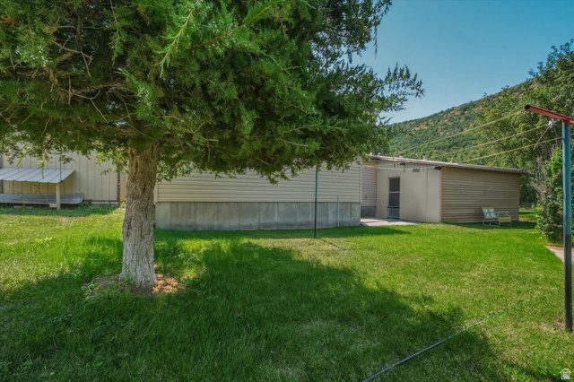 2405 Canyon Road Smithfield, UT 84335 - Photo 41 of 57 Expansive green lawn with mature trees