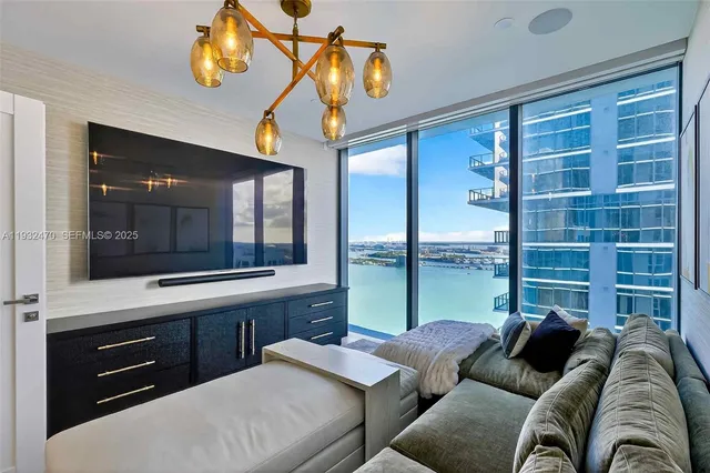 a bedroom with a bed and a flat screen tv in it