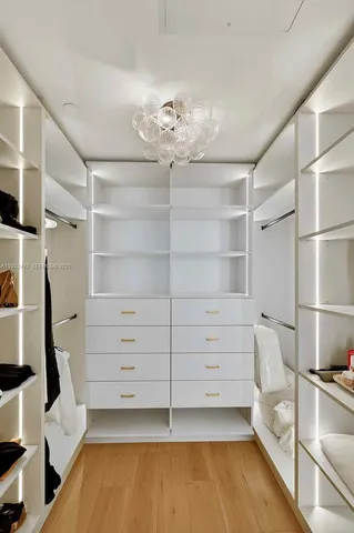 a living room with furniture a flat screen tv and a large window