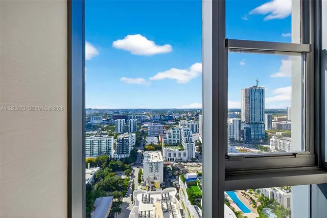 a view of a patio with a table and chairs under an umbrella
