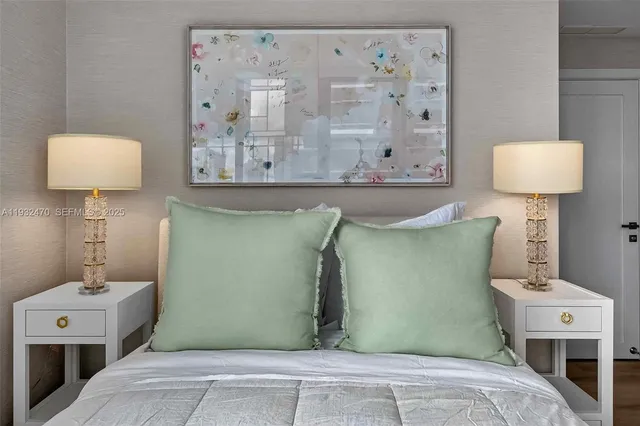 a bedroom with furniture and large windows