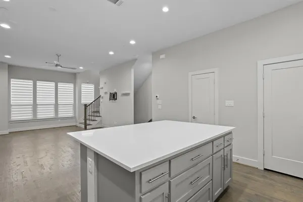 a kitchen with a table chairs and refrigerator