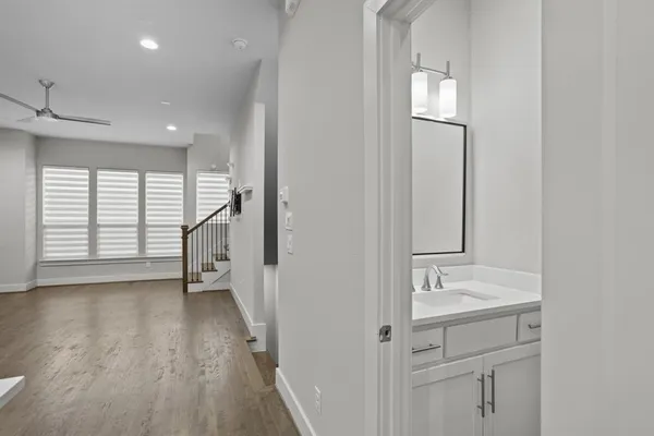 a view of hallway with wooden floor